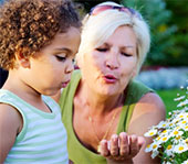 Photo of a woman and child looking at flowers.